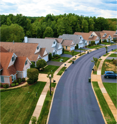 Aerial view of a curving road an a row of houses