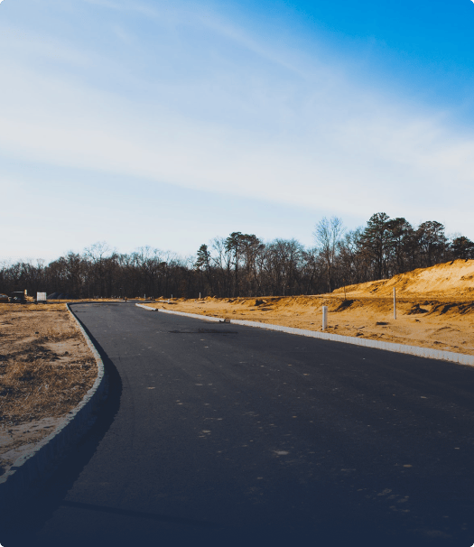 Winding asphalt road in middle of dirt field