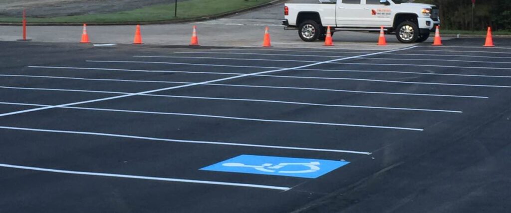 parking lot with freshly painted stripes and a handicap spot