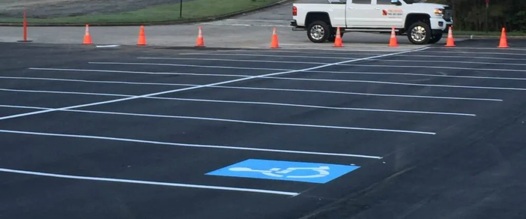 parking lot with freshly painted stripes and a handicap spot