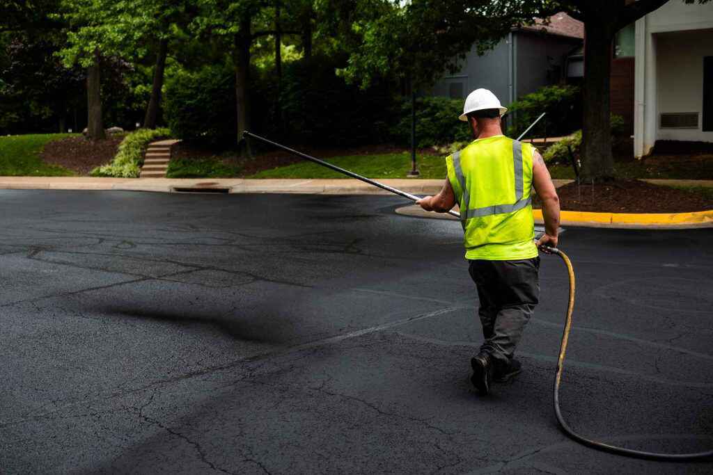 Asphalt Seal & Repair employee sealcoating a street