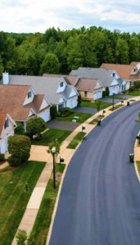 Aerial view of a curving road an a row of houses