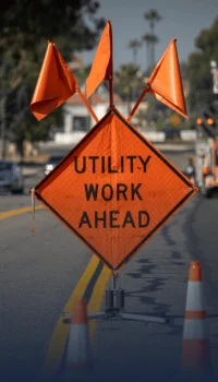 Orange utility work ahead sign